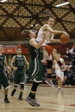 Freshman Blake Updike goes up over a Chekemeta defender for a pass.