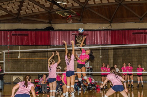 Freshman middle, Xayna Robinson, attempts to tip the ball over a block in Wednesday’s “Go Pink or Go Home” match against Linn-Benton.