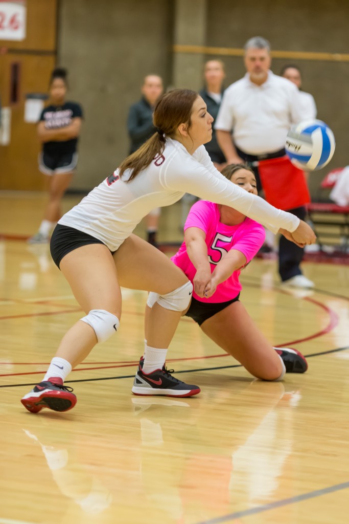 Photo courtesy of Robert Routson. Freshman Ashlyn Huntington (left) and sophomore Courtney Smith (right) dive for the ball after a Grey Harbor player slammed the ball over the net. Huntington took the save, passing the volleyball to other team members.