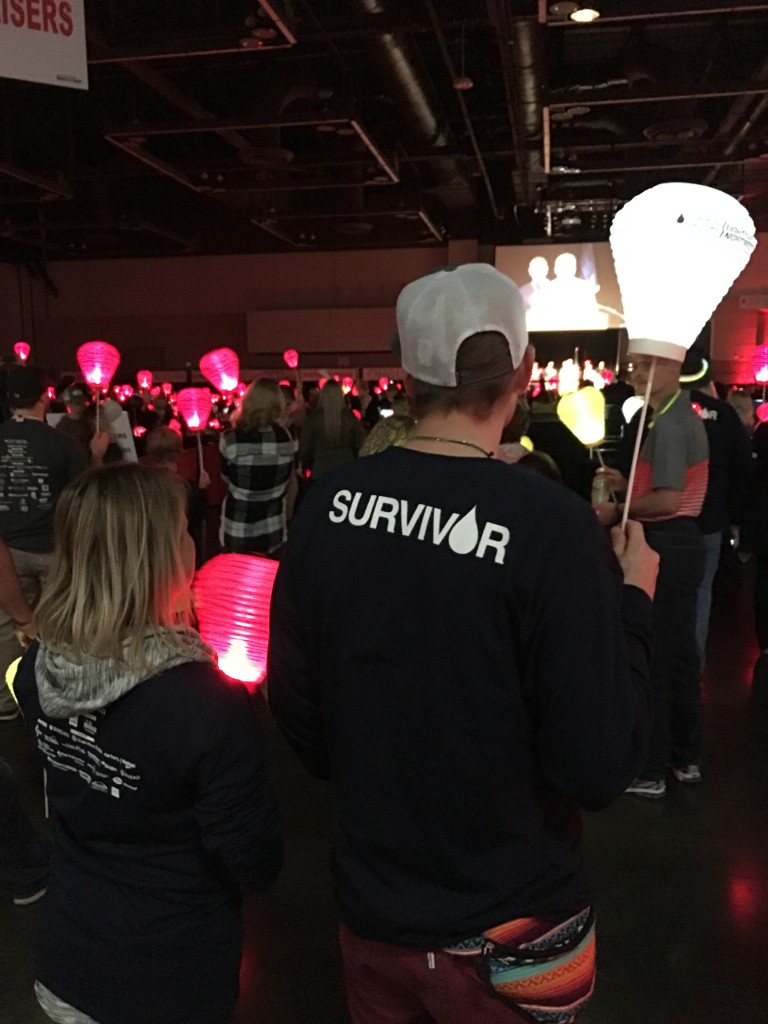 The author's brother standing next to his wife, holding up his white lantern. Photo by Matana McIntire.