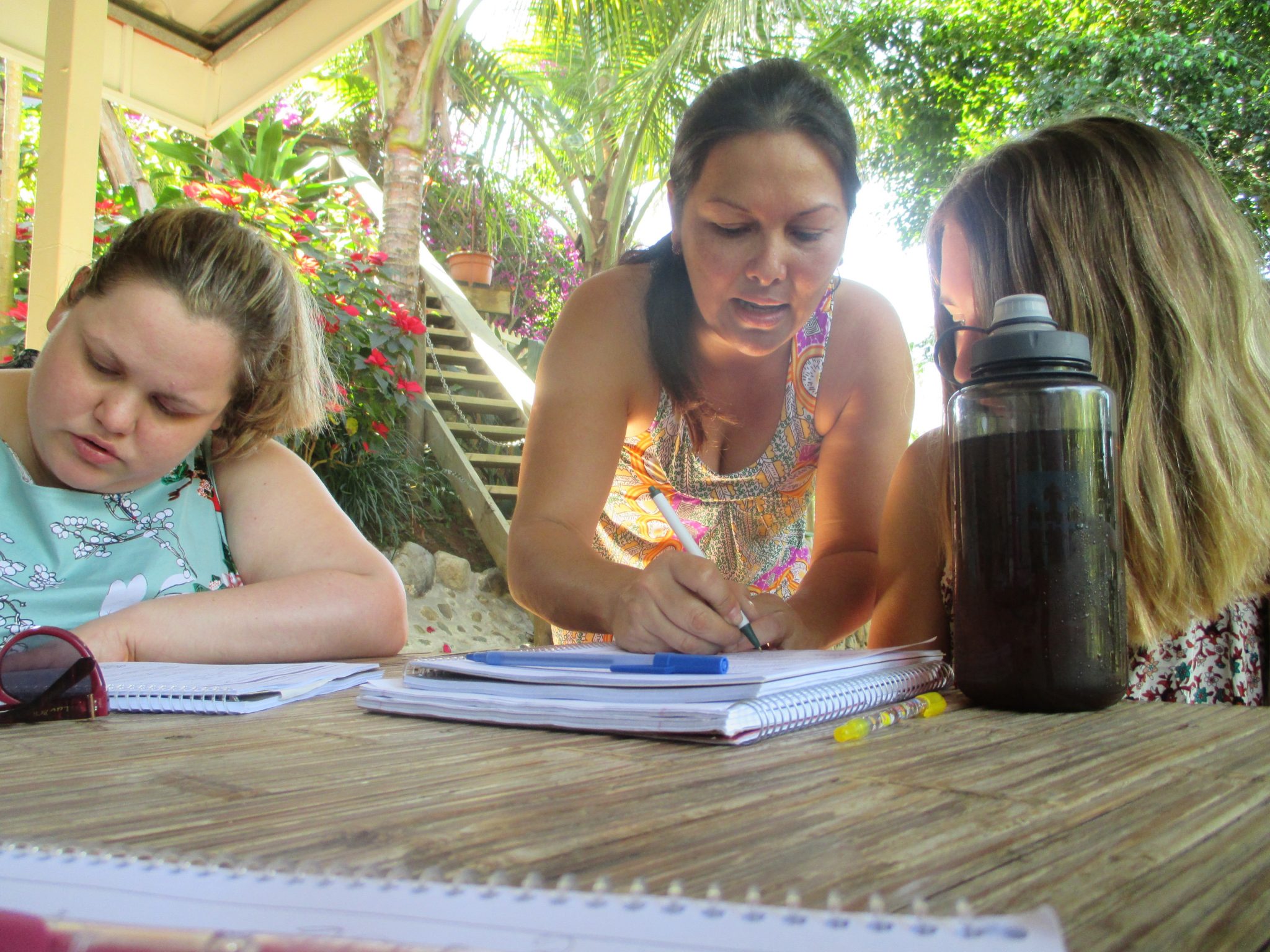 Two students and an instructor in class; Rashelle Carpenter (left), student; Glenda Jimenez (center), instructor; Johanna Hampton, behind water bottle.