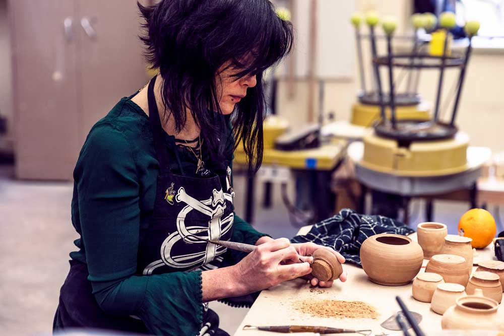 Kate Vincent, art student, works on her ceramic projects.