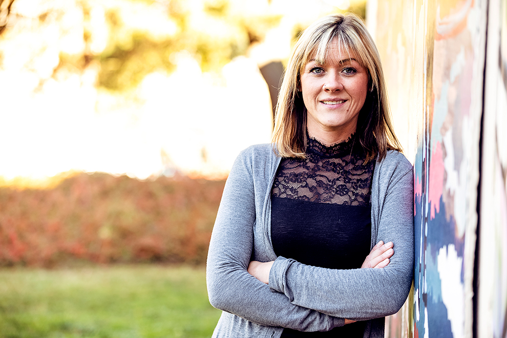 A photo of Kim Poling standing outside, smiling.