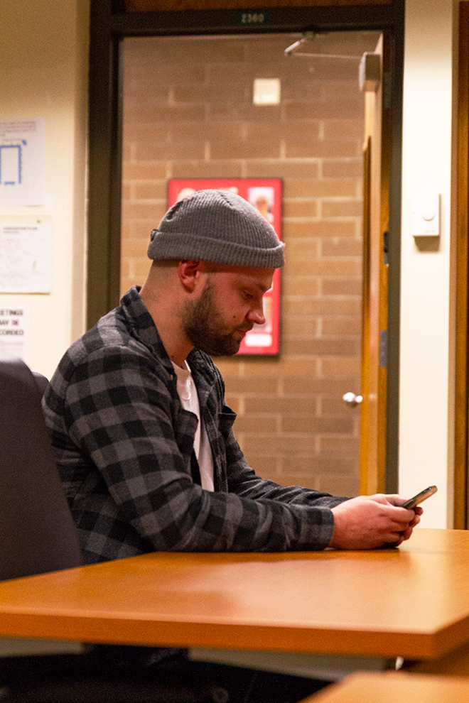 Photo of Devin Hardgrove during public input, reading his statement.