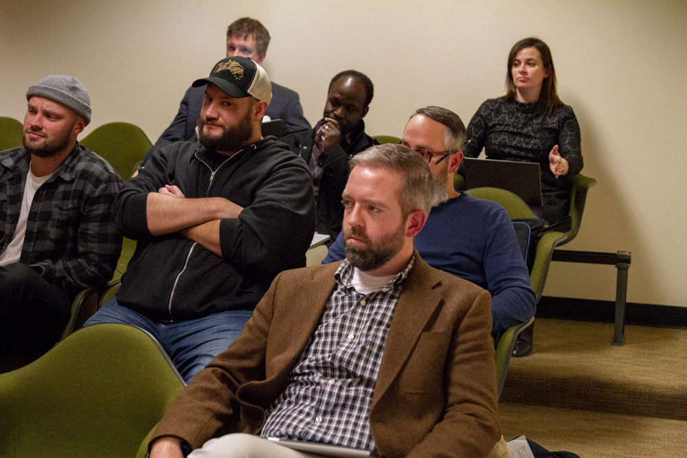 A photo of attendees listening to the KMHD discussion.