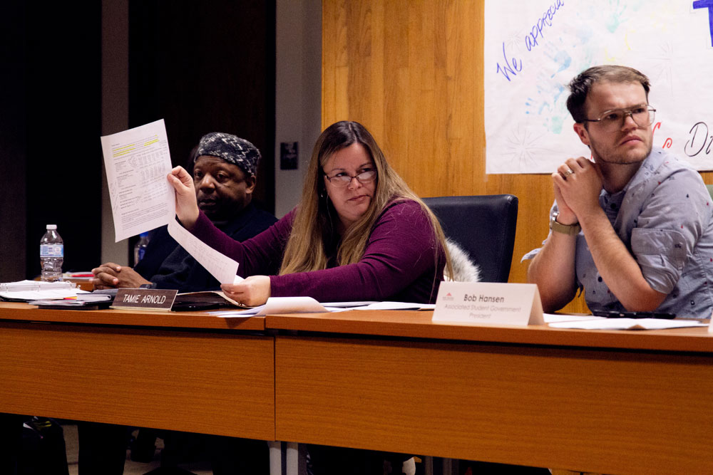 Photo of board member Tamie Arnold discussing previous financial history with Jennifer DeMent, chief operations officer at MHCC.