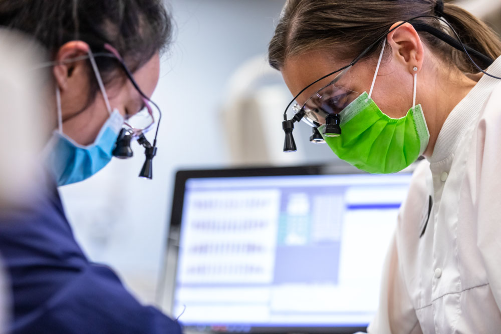 Photo of a Mount Hood dental hygiene instructor in the lab with a student in the program.