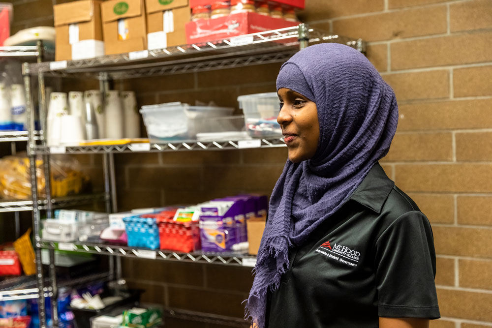 Photo of Fardwosa Duale, ASG Campus Safety & Sustainability Representative, helping stock the pantry after the acceptance of the Foundation donation on Jan. 24.