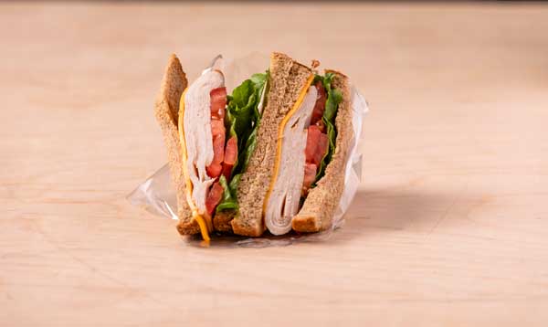 Photograph of a $4.00 half cold meat club sandwich from the Cafe on campus.