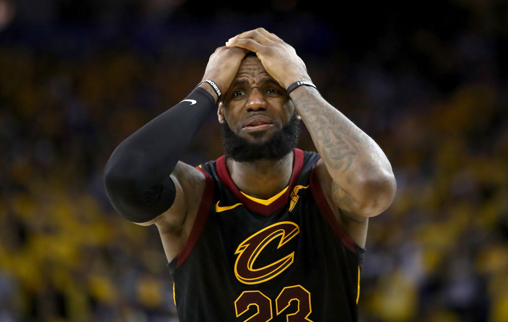 Lebron James with his hands on his head in frustration.