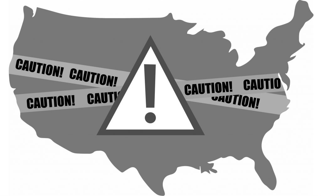 The outline of the United States with caution tape over it.
