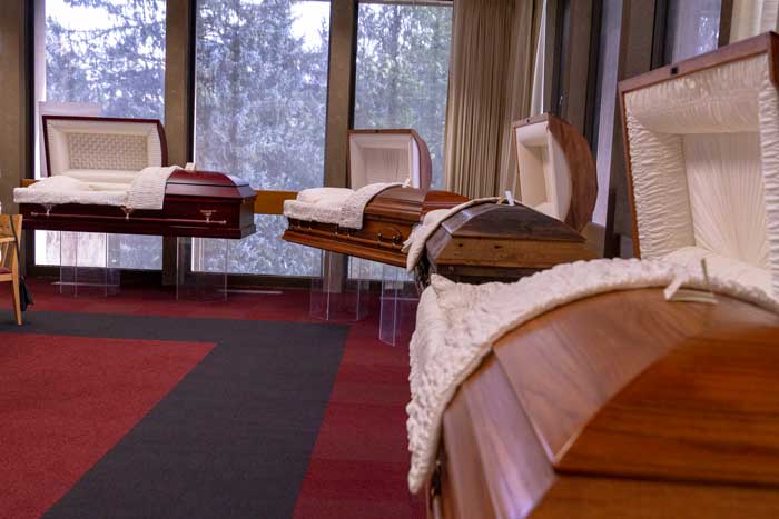 A row of caskets on display.