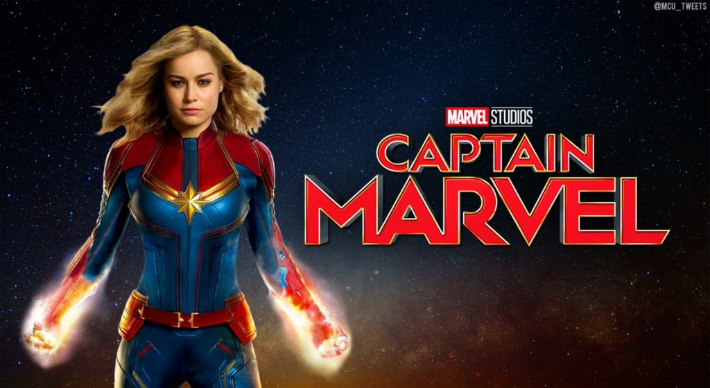 Captain Marvel poses at left with words "Captain Marvel" at right.