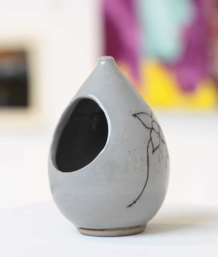 Grey Vase with a hole taking up a 1/3rd of the object