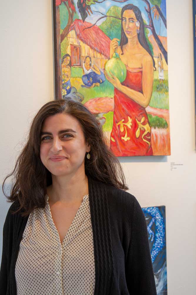 Suzanne Shonk standing in front of her self-portrait.