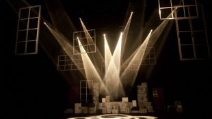 Theatre lighting on an empty stage in sepia tones.
